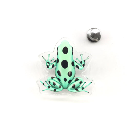 Green and black poison dart frog acrylic pin featuring Dendrobates auratus, with vibrant colors and detailed design from The Silk Ranch.