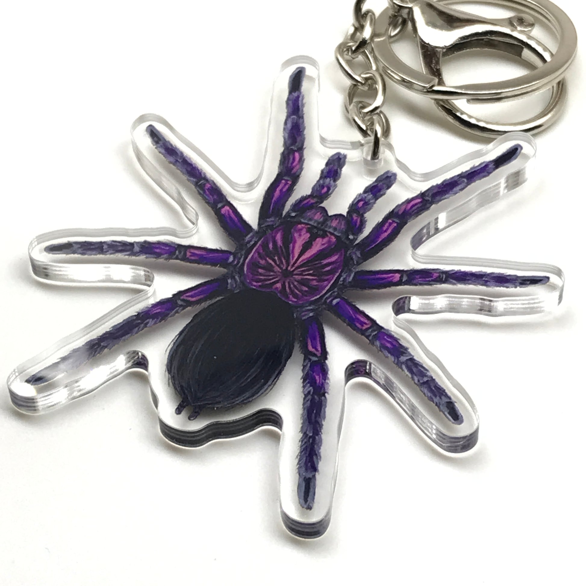 Purple Bloom Tarantula keychain featuring Pamphobeteus Sp. Machala acrylic charm, showcasing vibrant purple and intricate spider details.